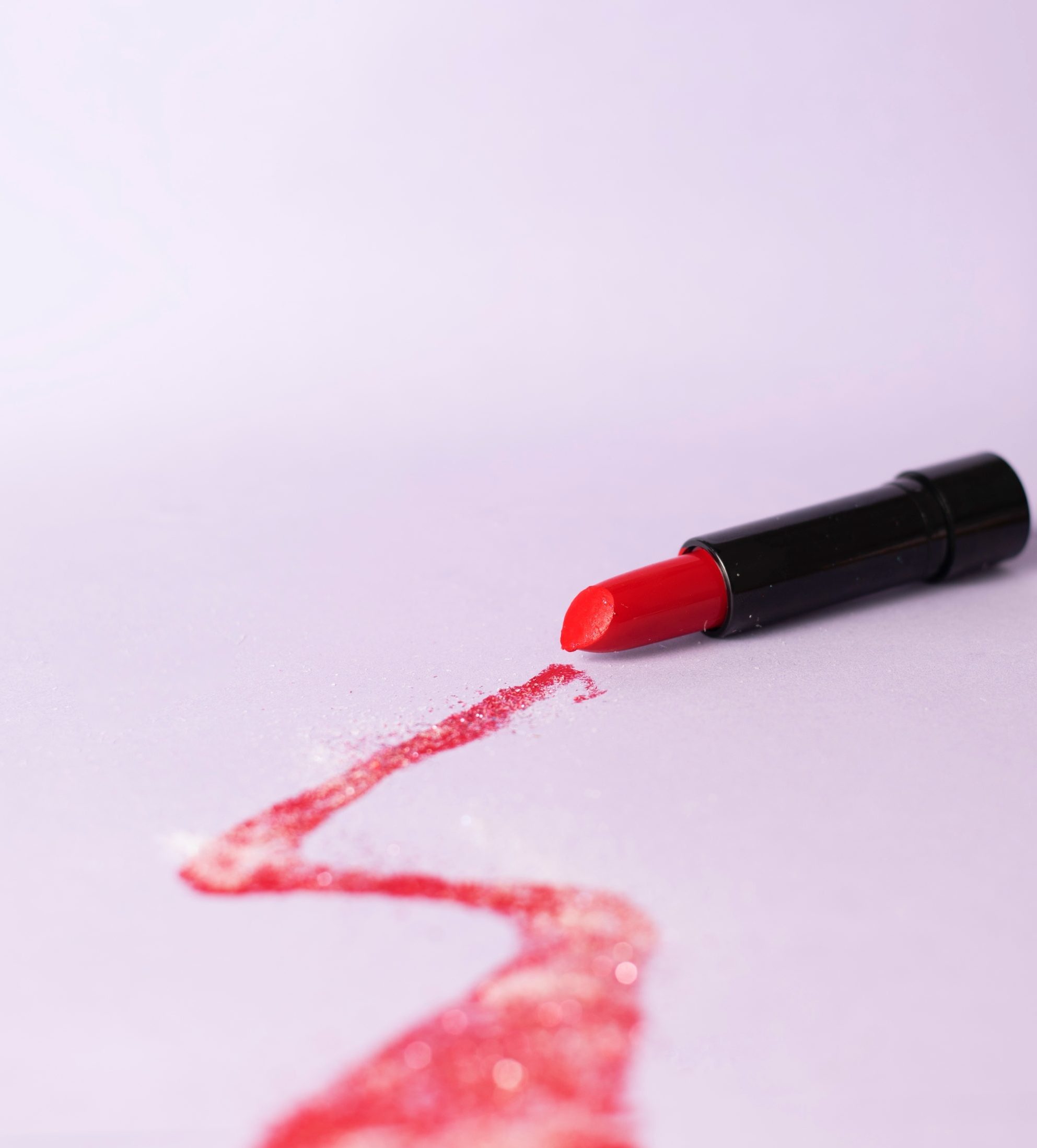 red lipstick with glitter plastic particles inside